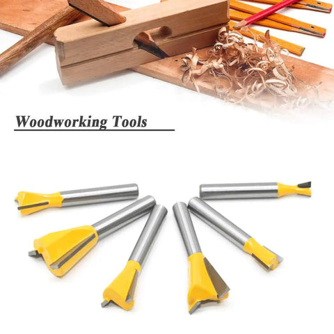 Shop Tested Six Piece Dovetail Router Bit Set Featuring One Quarter Inch Shank And Cutting Widths Spanning A Quarter To Seven Eighths Inches Crafted From Tough Tungsten Carbide For Knocking Out Tight Half Blind Woodworking Joints Dead On And Fast, displayed with wood shavings.