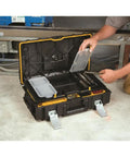 Person using Tough System Tool Storage Organizer with clear polycarbonate lid, beefy build, and removable cups on a workshop floor.
