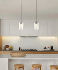 Top Shelf Modern Farmhouse Brushed Nickel Pendant Lights With Clear Glass Shades And Adjustable Rods, straight down view in kitchen.