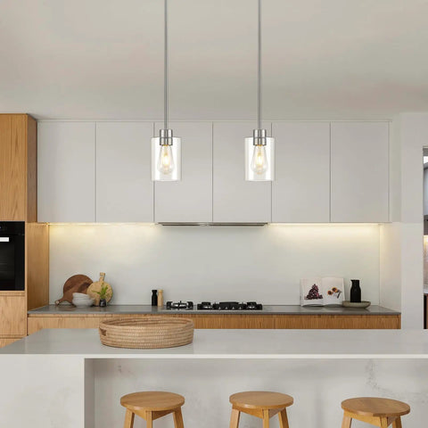 Top Shelf Modern Farmhouse Brushed Nickel Pendant Lights With Clear Glass Shades And Adjustable Rods, straight down view in kitchen.