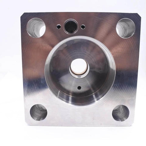 Front view of brushed metal waterjet intensifier end bell plate with central circular bore and four mounting holes.