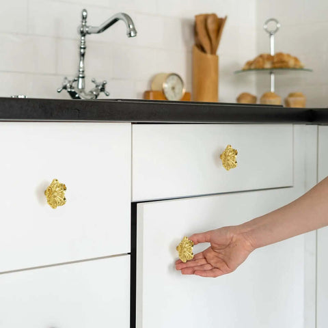 Kickstart Your Home Refresh With Vintage Gold Flower Cabinet Knobs And Brass Drawer Pulls An Eight Piece Hardware Set showing a hand opening a drawer with brass floral knob.