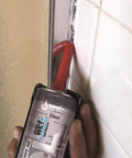 Applying Lexel Clear Sealant 5-Ounce Co-Polymer Rubber Adhesive Caulk to wet shower tile edge for indoor sealing.