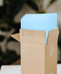 Open box of Milk Blue Bubble Mailer Bags 100 Pack Self Sealing Thickened 11x15 Plus 4 Inch Envelopes visible inside