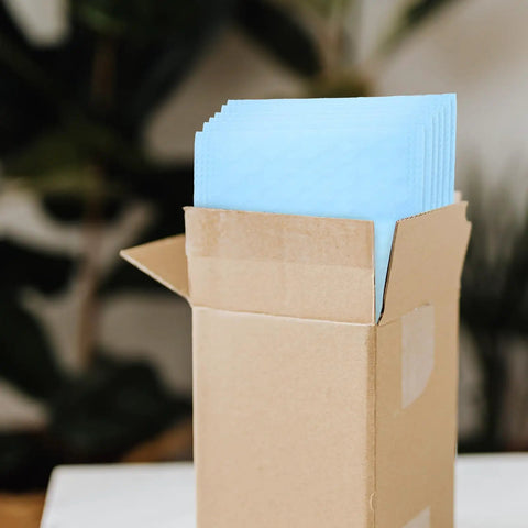 Open box of Milk Blue Bubble Mailer Bags 100 Pack Self Sealing Thickened 11x15 Plus 4 Inch Envelopes visible inside