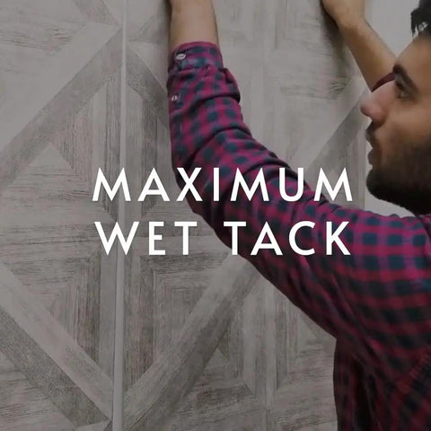 Man applying wallpaper with PRO 838 Heavy Duty Clear Wallpaper Adhesive For Non Wovens And Commercial Weight Wallcoverings