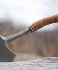 Sportsman's Axe 14 Inch Hatchet For Camping And Outdoors with forged steel head and leather grip on a log