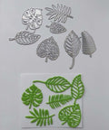 Totally Seven Piece Leaf Die Cut Set For Scrapbooking And Card Making with silver carbon steel leaf shapes and green stencil cutouts.