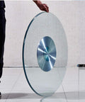 Heavy Duty Glass Lazy Susan Turntable with Sturdy Metal Base and 360 Degree Spin, shown held upright on edge.