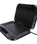 Top Rack Electric Panini Press Maker 750 Watt Indoor Grill For Home Cooked Steaks Burgers Breakfasts With Non Stick Aluminum Plate And Stainless Steel Build 9.3 x 5.1 Inches US Plug Easy Clean Design open black unit with nonstick grilling surface.