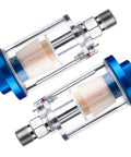 Two moisture separator filters for air compressors, clear glass bodies with blue aluminum caps, one quarter inch NPT connection.