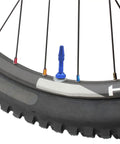 Close-up of bicycle wheel with colorful spoke caps, part of Colorful Spoke Cap Set For Mountain And Road Bikes, 60Pcs 14G Iron Nipple Caps, Lightweight Yet Rust Resistant Ride Ready Wheel Decorations, 7 Color Options To Personalize Your Bicycle Wheels.