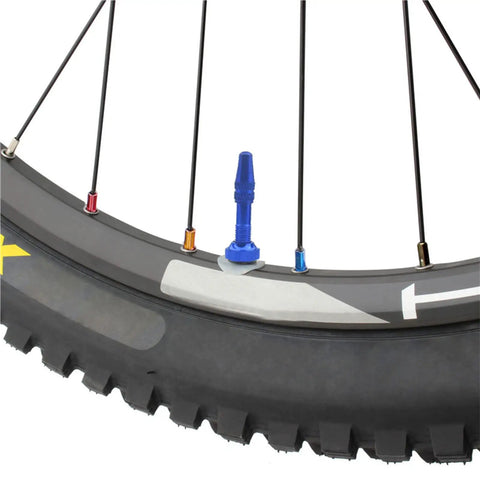 Close-up of bicycle wheel with colorful spoke caps, part of Colorful Spoke Cap Set For Mountain And Road Bikes, 60Pcs 14G Iron Nipple Caps, Lightweight Yet Rust Resistant Ride Ready Wheel Decorations, 7 Color Options To Personalize Your Bicycle Wheels.