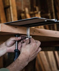 Hands securing a guide rail clamp 2 pack for track saws, sturdy no slip grip that holds rails firmly in place on a wooden surface