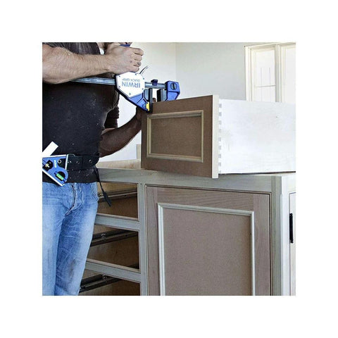Front view of two IRWIN Quick-Grip micro bar clamps, 4-1/4 in, one-handed, blue, in use on a cabinet assembly.