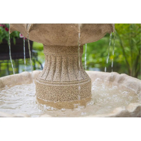 Stone fountain with water cascading into basin outdoors