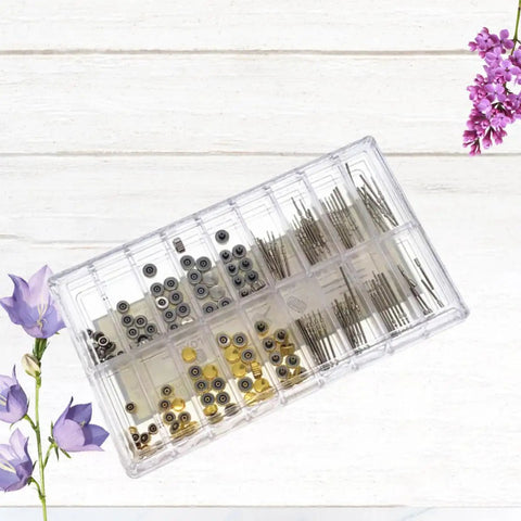 Pro Grade 170Pcs Watch Crown And Spring Bar Replacement Kit with assorted stems, tubes, and pins in plastic case on wooden background.
