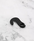 Heavy Duty Aluminum Alloy Rear Derailleur Hanger Tail Hook For Trek Road Gravel Bikes Nine Mm Mount on marble surface