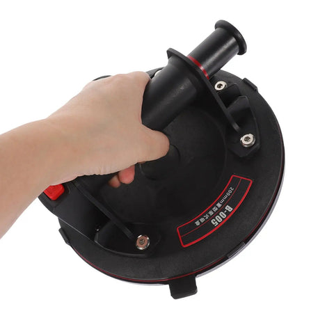 Heavy Duty Glass Suction Cup Lifter With Pressure Gauge And Thickened Rubber Build held in hand, ideal for smooth surfaces.