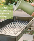 Watering Extra Tough No Holes Seed Starting Trays 5 Pack Built To Last Durable BPA Free Plastic Nursery Flats in use outdoors