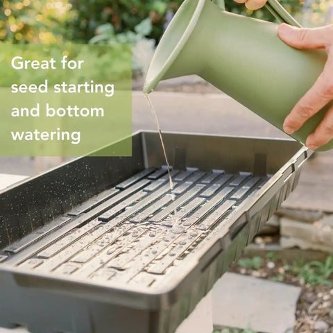 Watering Extra Tough No Holes Seed Starting Trays 5 Pack Built To Last Durable BPA Free Plastic Nursery Flats in use outdoors