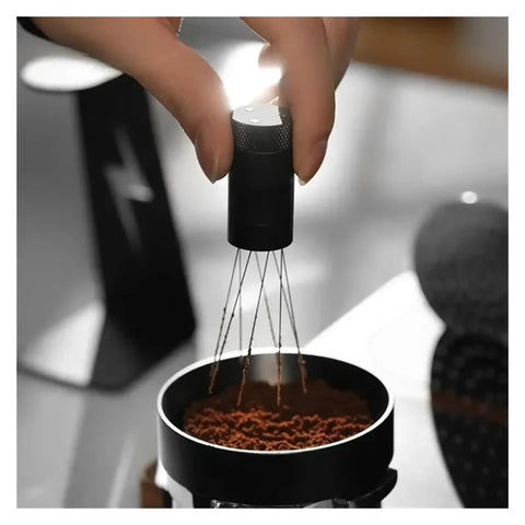 Level Up Your Daily Grind With This Adjustable Wdt Espresso Coffee Stirrer Featuring Rotating Needle Spread Magnetic Holder And Six Spare Tips For Flawless Shots No Cap, hand holding tool over coffee grounds.
