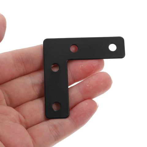 Close-up of a hand holding a black stainless steel L shaped corner brace, part of a 20 pack for picture frames and desk supports.