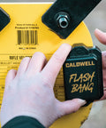 Close-up of the Flash Bang Hit Indicator from AR500 Long Range Gong Kit next to product label on rifle steel target.