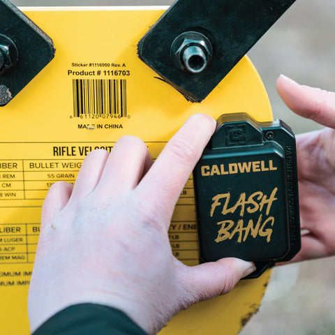 Close-up of the Flash Bang Hit Indicator from AR500 Long Range Gong Kit next to product label on rifle steel target.