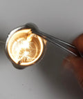 Close-up of Six Piece Spark Lighter Torch Set with twenty extra flint replacements in use for welding, sparking flame visible.