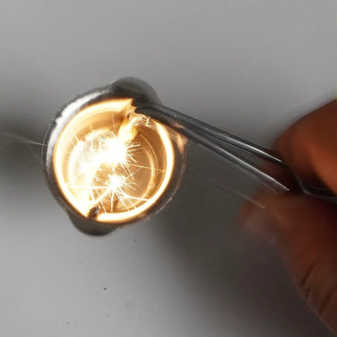 Close-up of Six Piece Spark Lighter Torch Set with twenty extra flint replacements in use for welding, sparking flame visible.
