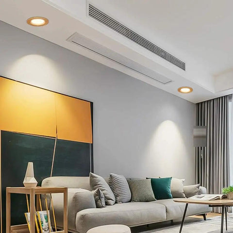 Image of living room featuring JUDYSSY 11Pack Wood Color Round Recessed Downlight lighting over a sofa, showcasing its elegant design.