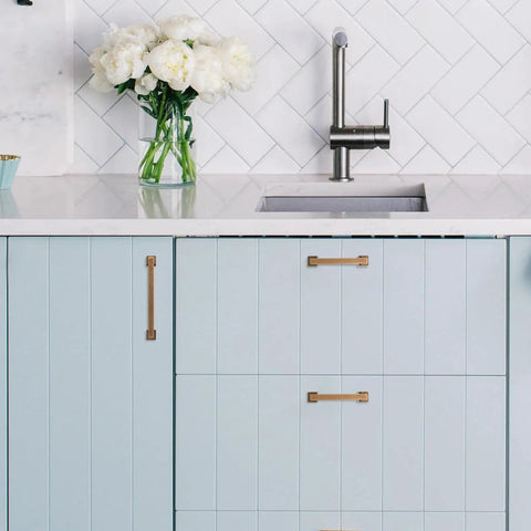 Hella Durable Five Inch Antique Brass Cabinet Pulls And Drawer Handles With Smooth Satin Finish on blue cabinets in kitchen.