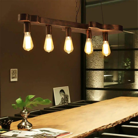Dope Bronze Linear Island Light With Guitar Shade, Industrial Farmhouse Ceiling Fixture over wooden table, 5 bulbs lit