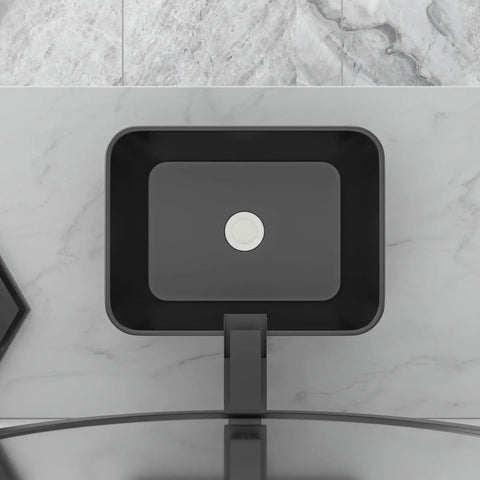 Top view of a rectangular black sink installed on a marble countertop for modern bathrooms