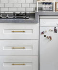 Champagne Bronze Cabinet Pulls in 5 Inch Hole Center for Cupboard and Drawer installed on white kitchen cabinets.