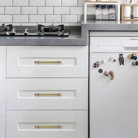 Champagne Bronze Cabinet Pulls in 5 Inch Hole Center for Cupboard and Drawer installed on white kitchen cabinets.