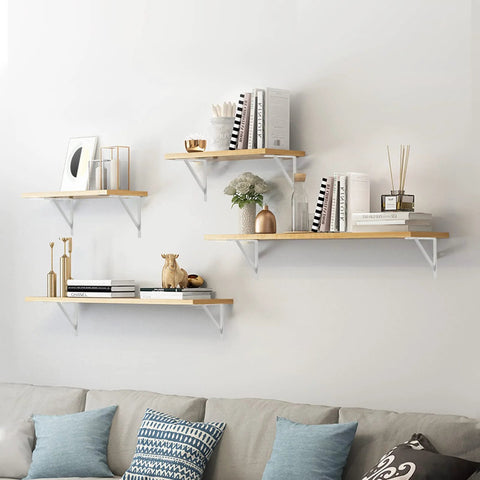 Wall-mounted shelves on living room wall supported by Heavy Duty 12-Inch By 8-Inch Shelf Brackets With 600 Lb Capacity 10 Pack White Metal L Supports.