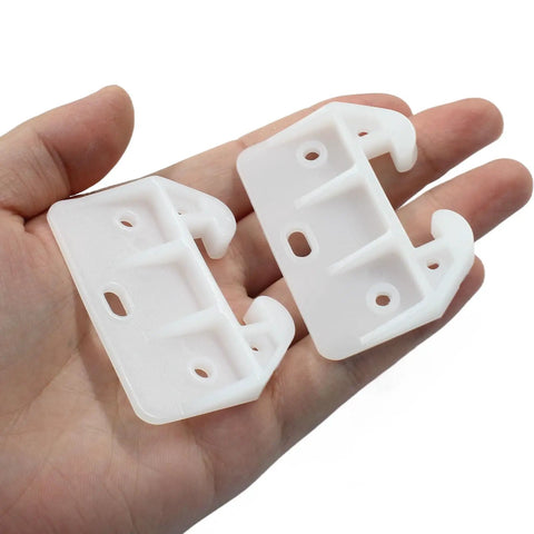 Smooth As Butter White Plastic Drawer Slide Rails 8 Pcs Rock Solid Furniture Track Brackets in a hand, showing two durable plastic pieces.
