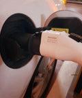 Hella Reliable EV Charger Adapter J1772 To Type 2 Socket IEC 62196 charging connector plugged into vehicle socket.