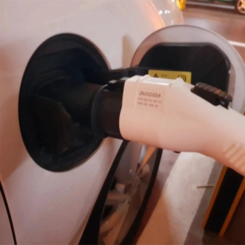 Hella Reliable EV Charger Adapter J1772 To Type 2 Socket IEC 62196 charging connector plugged into vehicle socket.