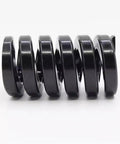 Super Tough Black Alloy Steel Compression Spring 75mm Length And 22MM Outer Diameter viewed from the side, showcasing its durable design.