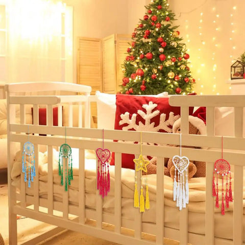 DIY Dream Catcher Kit For Beginners 24 Piece Colorful Mini Ornament Making Set With Star Moon Heart Round Shapes For Bedroom Car Mirror Keychain Bag Craft Projects displayed on a crib.
