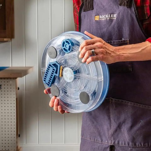 Person holding Pro Grade Saw Blade Cleaning Kit For Circular Table And Miter Saws 6 1/4 To 12 Inches with clear dish and grips