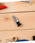 Rock Solid Stainless Steel Spring Plunger With Integrated Reset Mechanism and Precision Fine Thread on wood surface with tools.