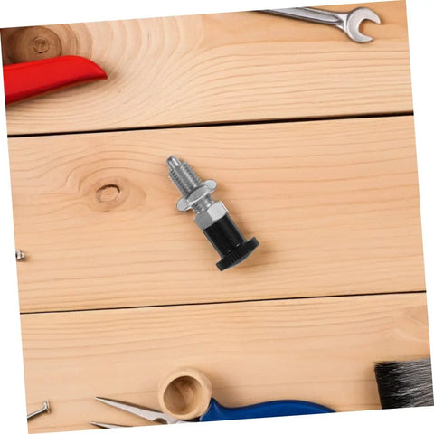Rock Solid Stainless Steel Spring Plunger With Integrated Reset Mechanism and Precision Fine Thread on wood surface with tools.