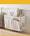 Cotton Linen Nightstand Hanging Bag with Metal Bracket and Multiple Pockets for Bunk Beds showing books and teddy bear