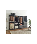 Freestanding Gray Wood Closet System With Five Modular Wardrobe Units For No Stress Setup Clean Vibes Ultimate Storage Flex Super Easy Game Changing Room Layout organized with hanging garments and drawers.