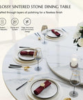 Modern 51 Inch Round Dining Table Slick Glossy White Sintered Stone Top Built Tough Black X Carbon Steel Base Lazy Susan set for dining.