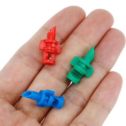 Close-up of red, green, and blue nozzles from 150 Piece Drip Irrigation Emitter Set With Drill Tool Micro Sprinklers 90 180 360 Degree